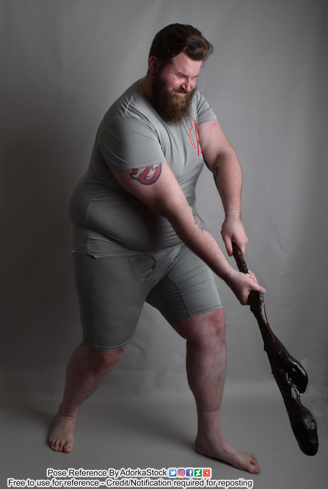 Large man strains to use club